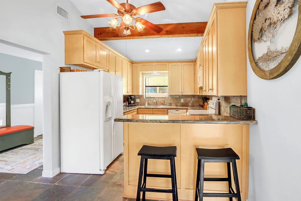 The kitchen is off of the foyer