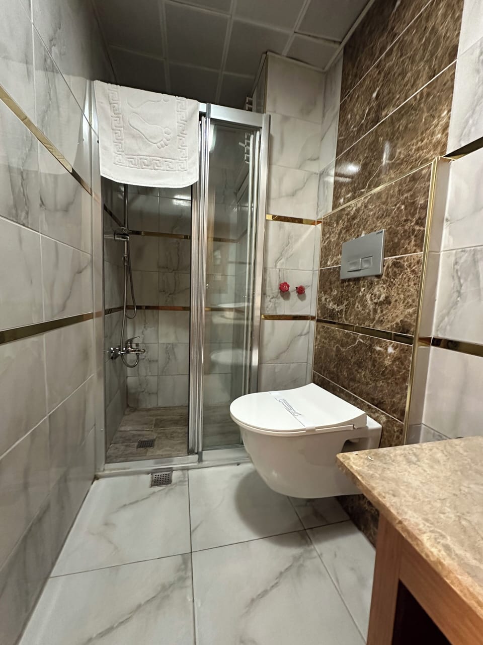 Shower, hair dryer, slippers, towels