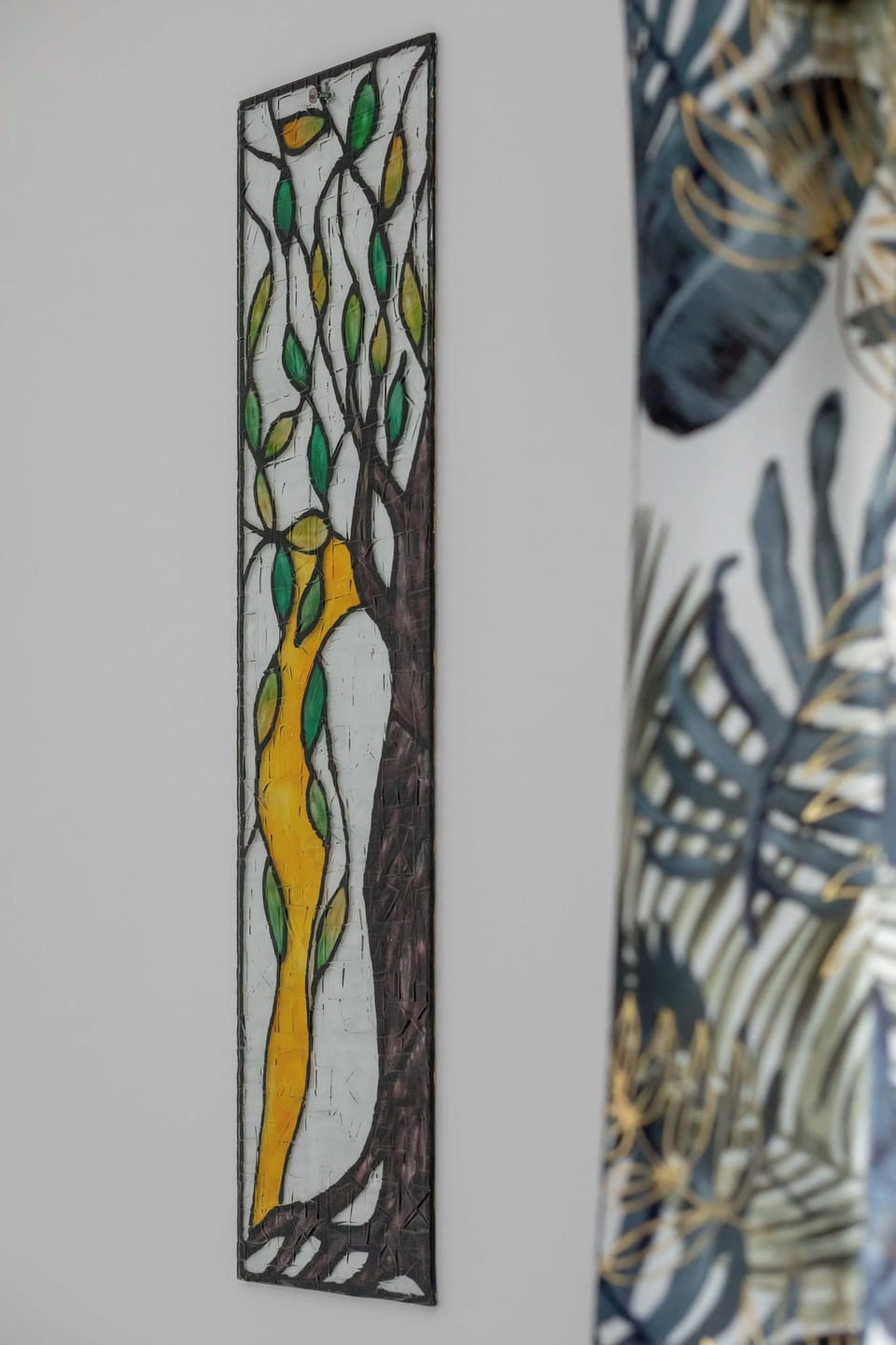 A decorative detail of patterned wall art, adding color and personality to the interior. The design complements the overall modern aesthetic.