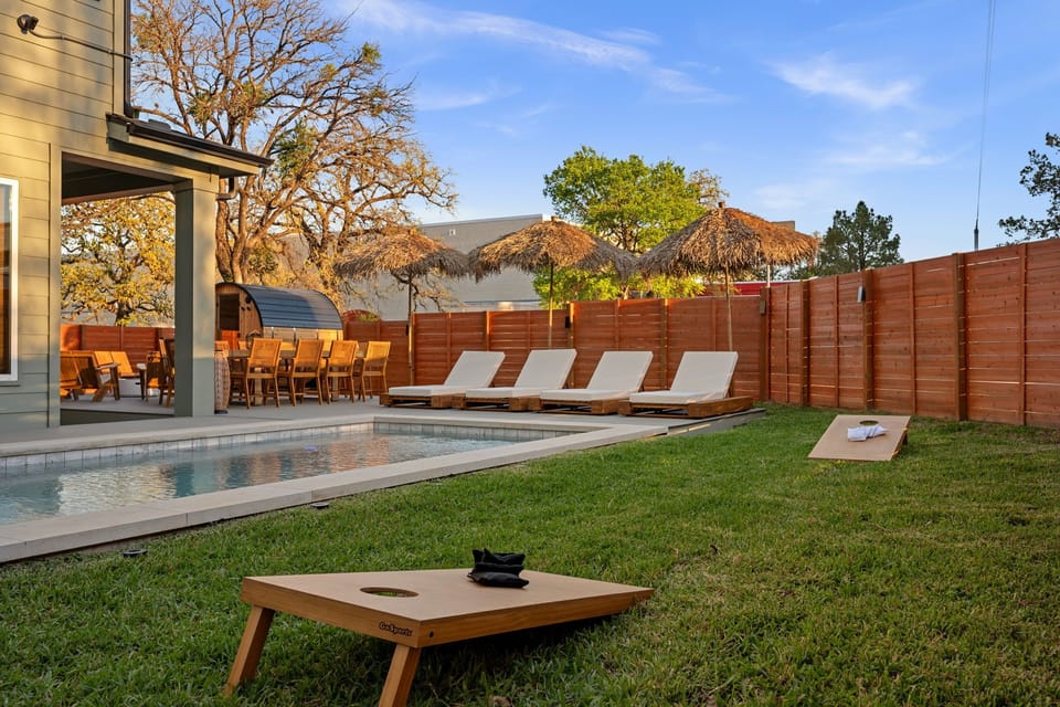 Spacious backyard with lounge seating and yard games—ideal for relaxing and group hangouts.