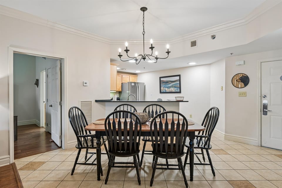 Gather around your welcoming dining table beneath elegant lighting for memorable meals together in your bright, open-concept space.