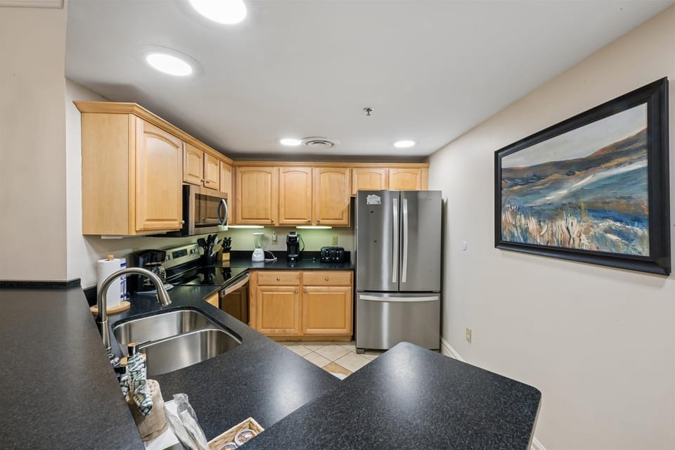 Your fully equipped kitchen features gleaming granite countertops, stainless steel appliances, and warm wood cabinetry for all your culinary adventures.