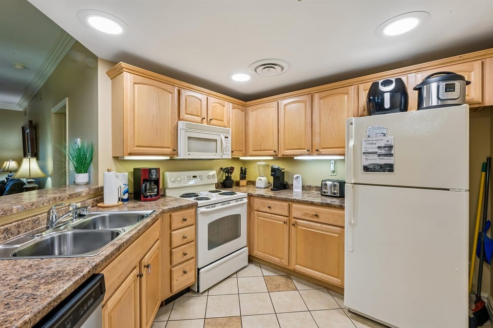 Prepare your favorite meals in this fully equipped kitchen with granite counters, modern appliances, and everything you need for a comfortable stay.
