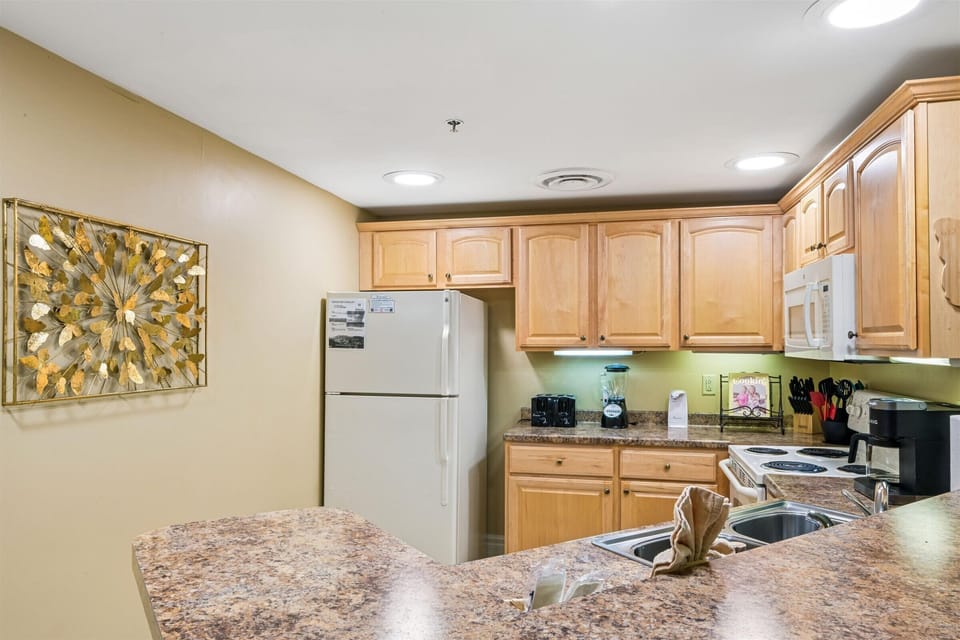 Your fully equipped kitchen features granite counters, maple cabinets, and everything needed for memorable meals during your stay.