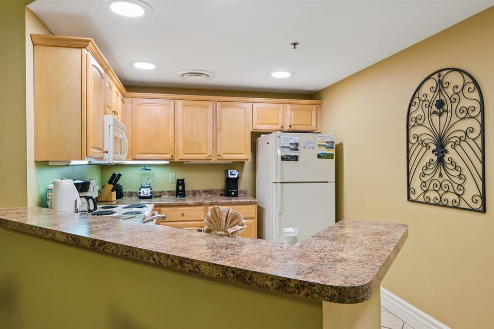 Your fully equipped kitchen awaits with granite counters, maple cabinets, and everything you need to create memorable meals during your stay.