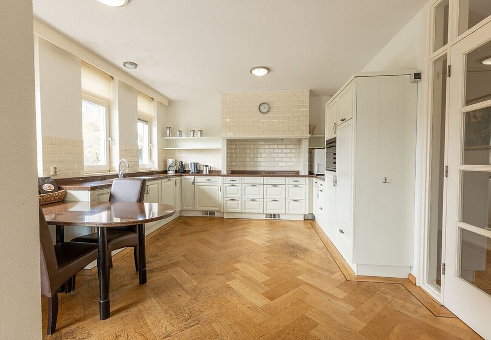 kitchen with oven, stovetop, and table