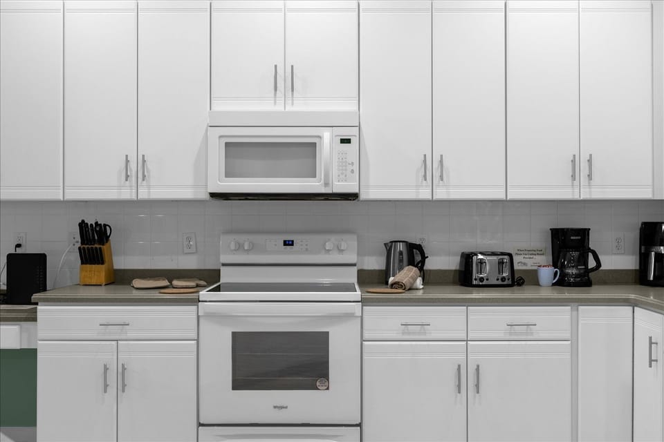 Kitchen with Microwave, Stove, Toaster, Kettle, &  Coffee Maker