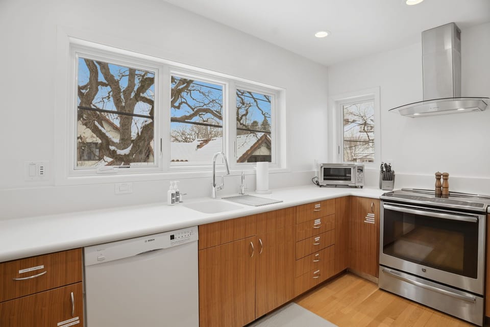 Step into your stylish and functional kitchen where natural light floods the space, creating the perfect backdrop for preparing delicious meals during your stay.