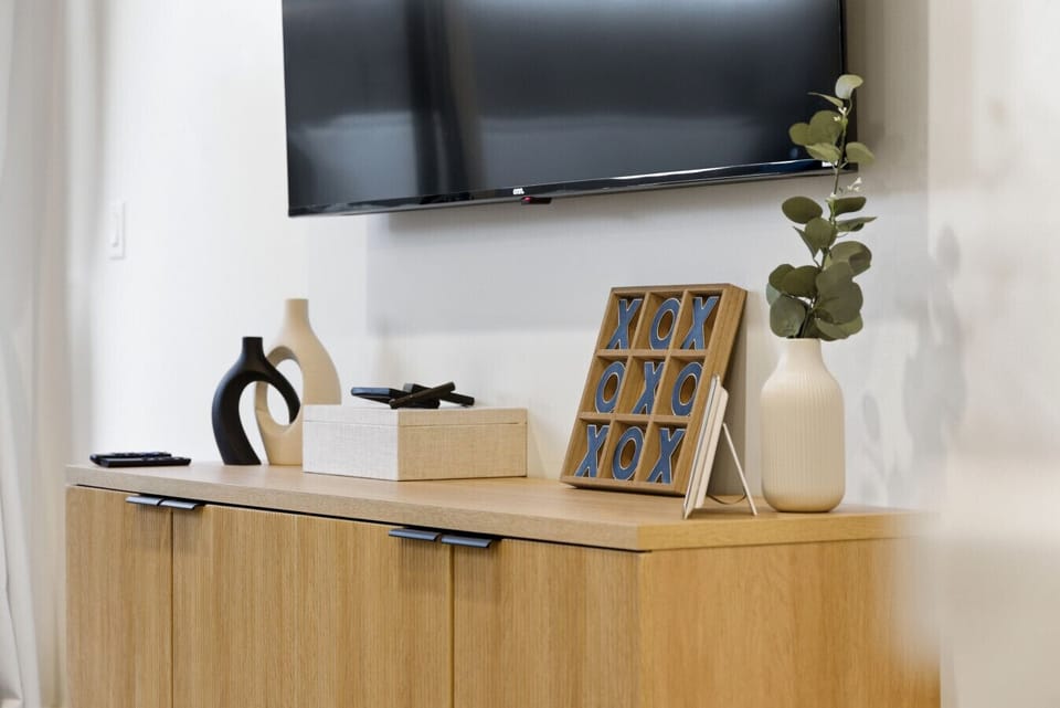 Living Room: Stylish decor invites relaxation with a sleek TV and vibrant accents!