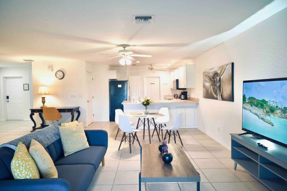 The living room and dining area are fully integrated into the kitchen
