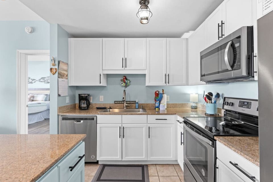 Fully equipped kitchen with modern appliances, granite countertops, and plenty of space to cook.