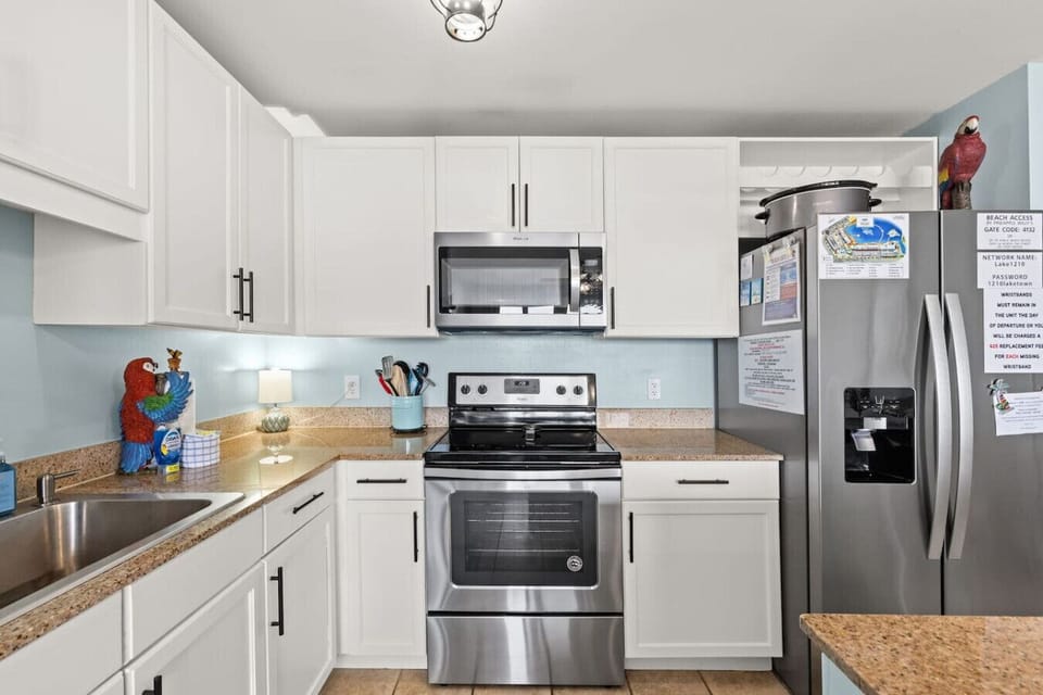 Bright kitchen with stainless steel appliances and everything needed for easy meal prep.