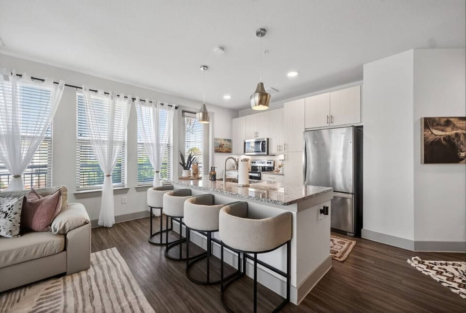 Kitchen: Chic kitchen and living combo with modern finishes, bar seating, and plenty of room to gather and unwind.