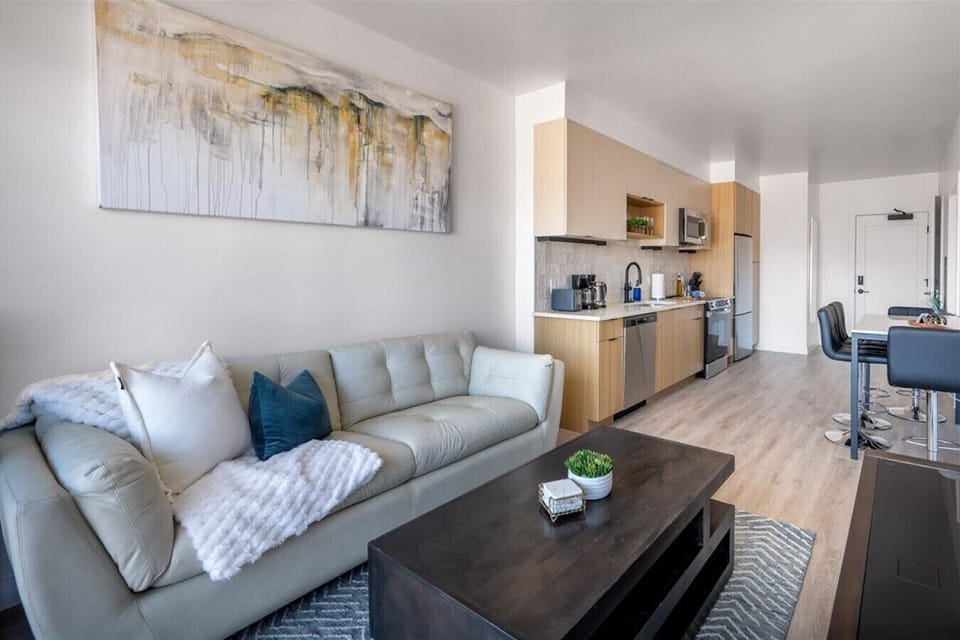 Beautifully designed living room. 60` TV, leather sofa and amazing views of mountains and city skyline.