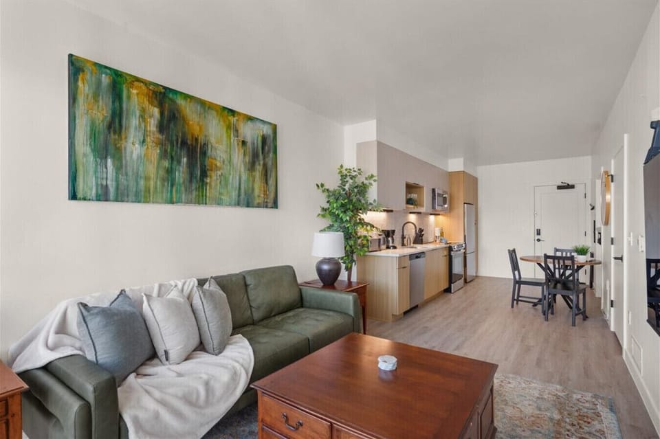 Beautifully designed living room. 60` TV, leather sofa and amazing views of mountains and city skyline