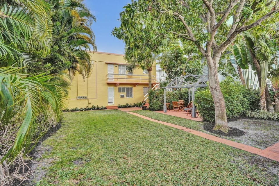 Colorful building exterior with lawn and palm trees