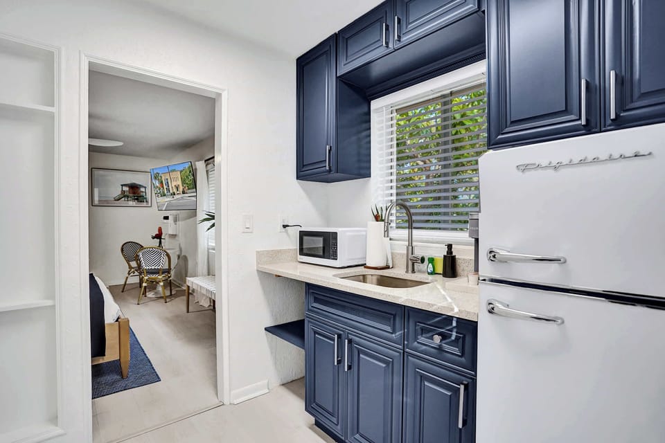 Kitchenette opening to bedroom sitting area beyond