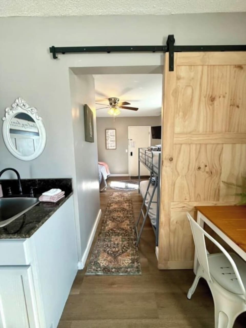A barn door that closes for privacy between the two bedrooms.