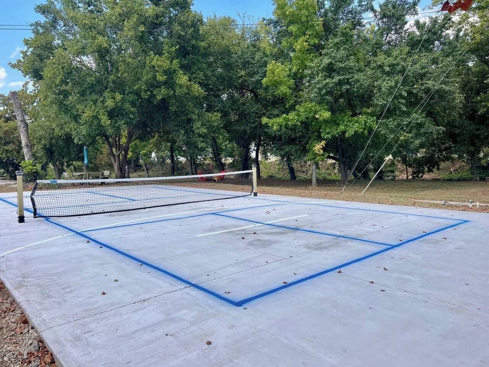 Pickle ball paddles are located in the grill area.