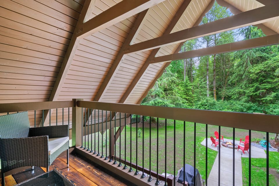 Covered upper deck with forest views, perfect for morning coffee surrounded by towering evergreens