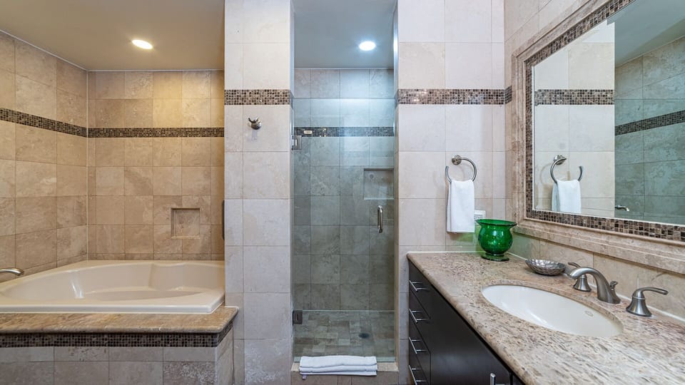 Master bathroom with bathtub and shower
