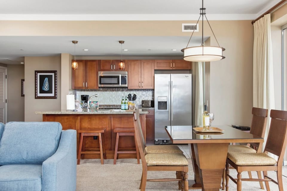 Modern island kitchen with dining, wine, and sunshine-ready relaxation space. HKK-539