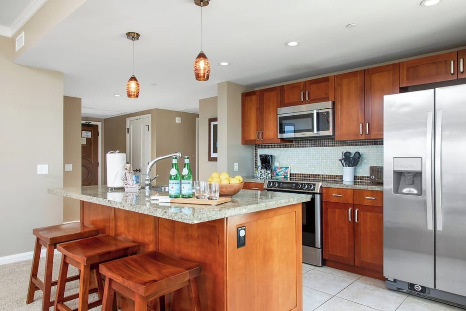 Stylish gourmet kitchen with island seating, stainless steel, and elegance. HKK-539