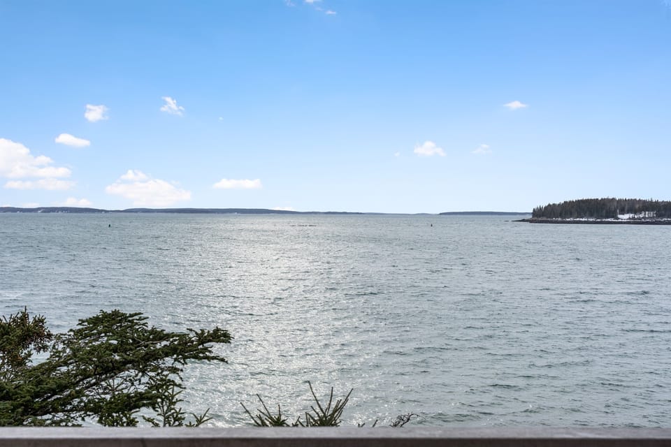 Where the forest meets the sea. This elevated vantage point from your private deck offers unobstructed views of the North Atlantic and the daily rhythm of Bass Harbor. The perfect spot for golden hour sunsets near Acadia National Park.