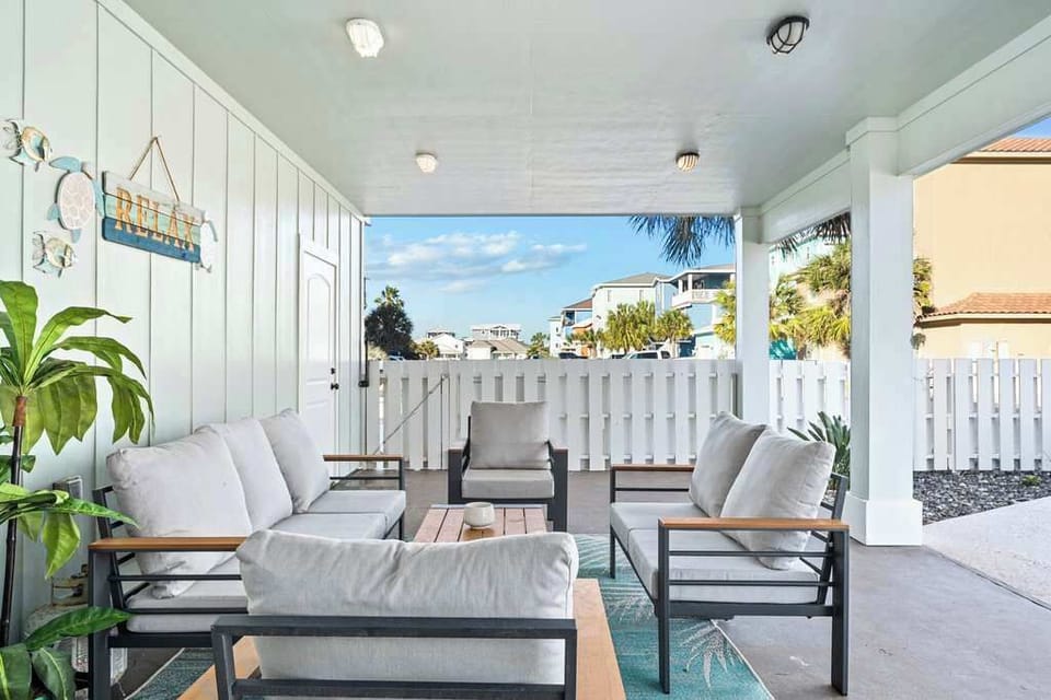 Bright covered patio with cozy seating—perfect for outdoor lounging.
