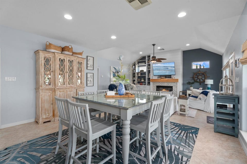 Dining area with large farmhouse table and seating for family meals in an open living space.