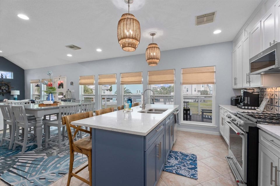 Bright kitchen and dining area with open layout and large island perfect for entertaining.