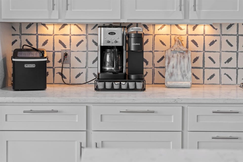 Stylish kitchen backsplash with stainless steel oven, stove, and modern cooking space.
