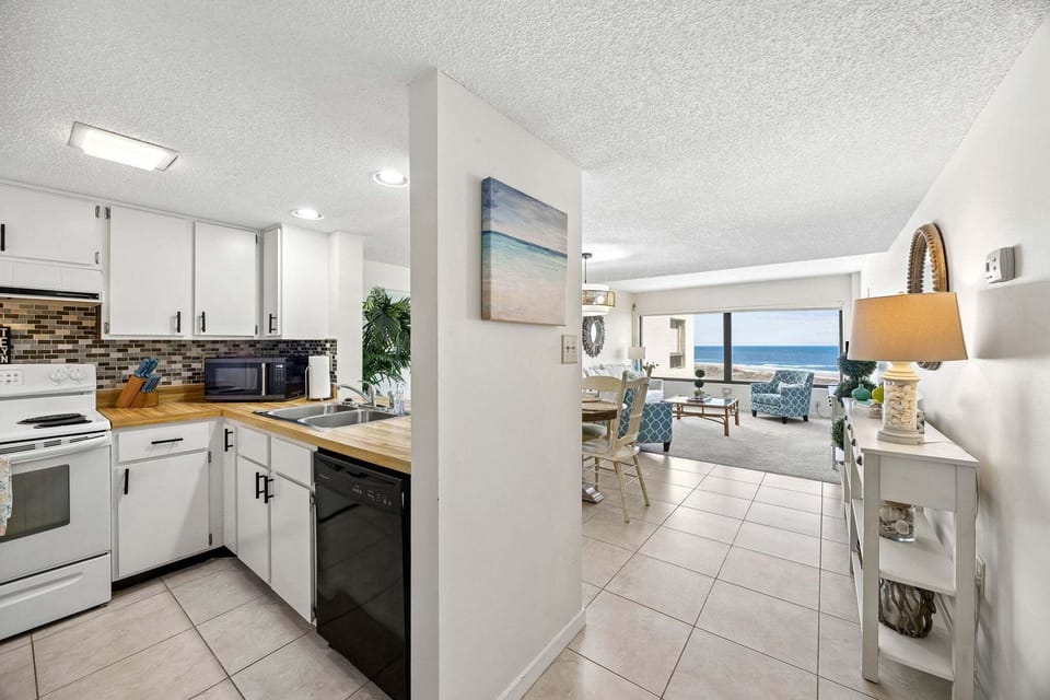 Foyer and view of kitchen, dining area, and living room