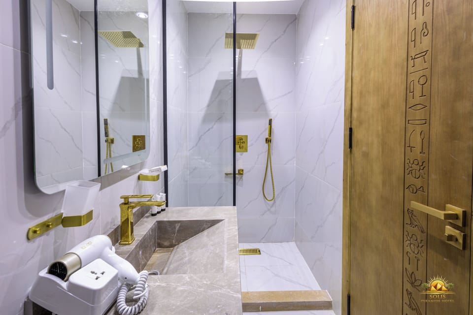 Deluxe Room | Bathroom | Shower, hair dryer, towels, soap
