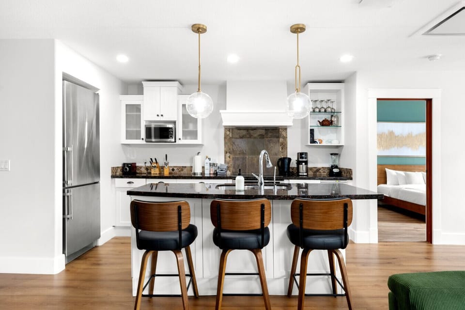 The stylish breakfast bar offers seating for three more, ideal for casual dining or quick snacks.