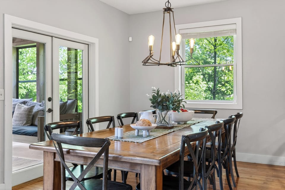 Bright dining space with seating for the whole group and easy access to the deck.
