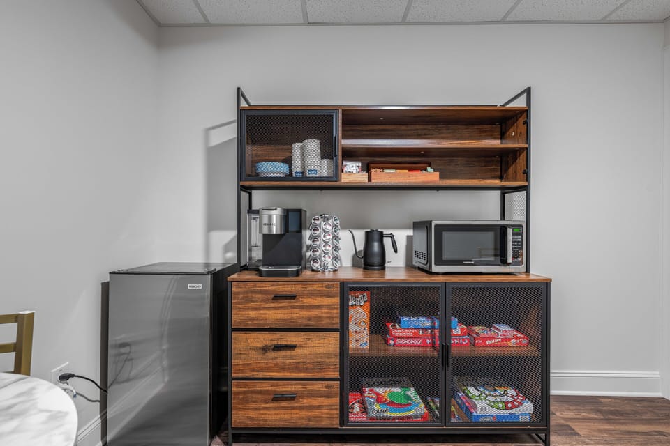 Guests enjoy access to shared amenities including a coffee station, microwave, mini fridge, and light snack options — a convenient bonus to your private Deluxe King Suite.