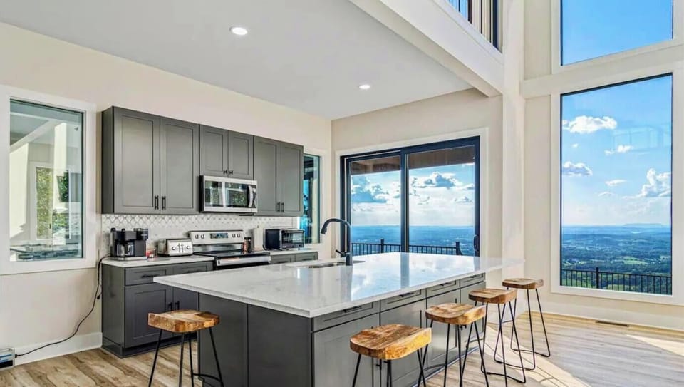 The kitchen's sleek marble countertop is both stylish and functional, perfect for preparing meals with a view.