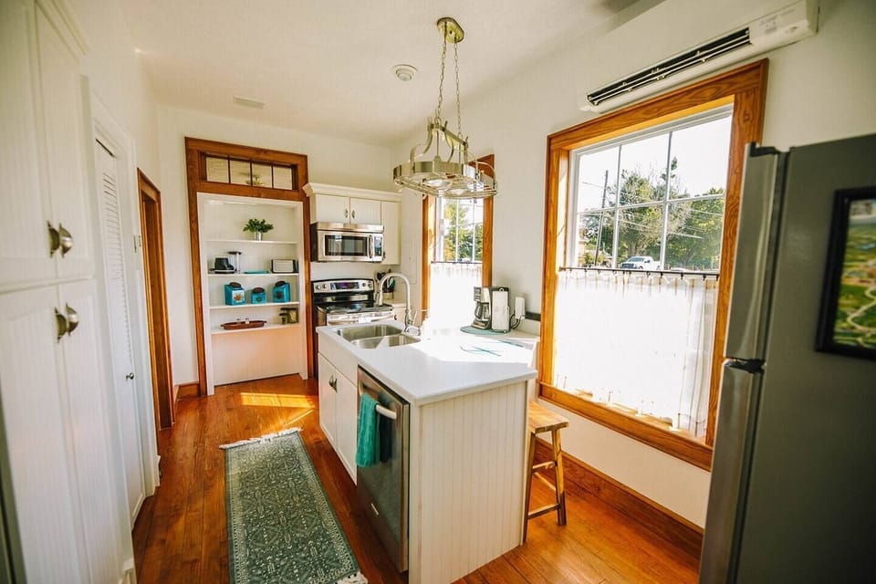 This bright, fully equipped kitchen, plenty of cabinet space, and a center island.