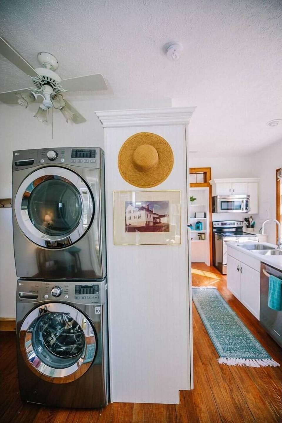 Convenient in-unit laundry featuring a modern, stacked washer and dryer located just off the kitchen.