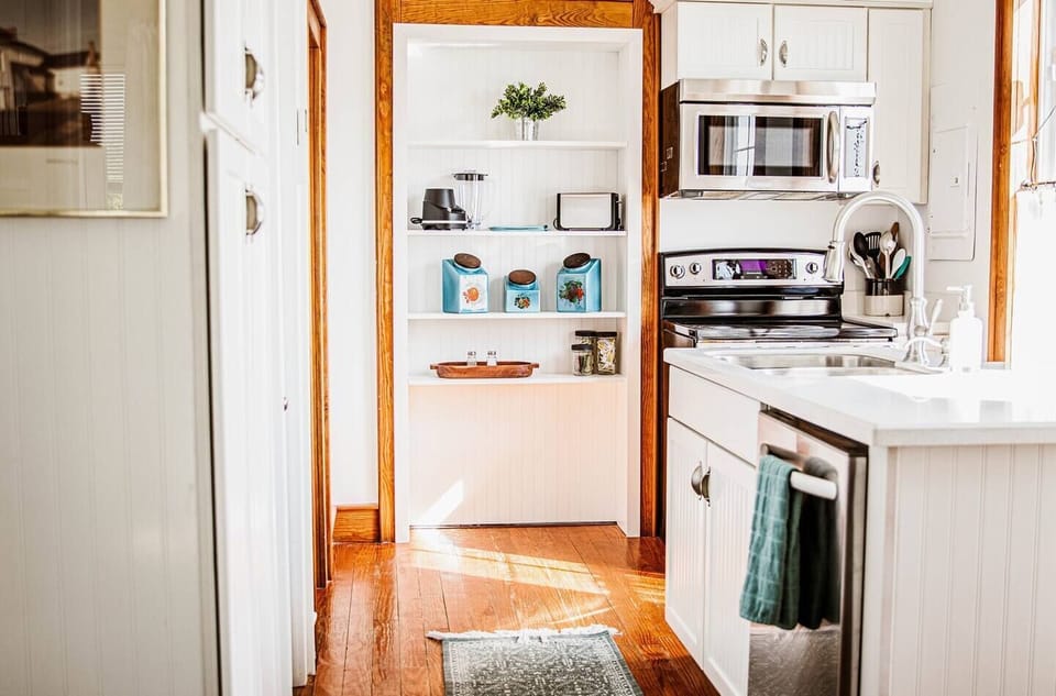 This bright kitchen nook features convenient built-in shelving for small appliances and essentials.