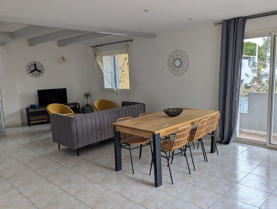 Large living room with lounge and dining room opening onto the terrace