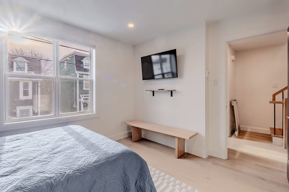 Bright bedroom with Smart TV & workspace bench