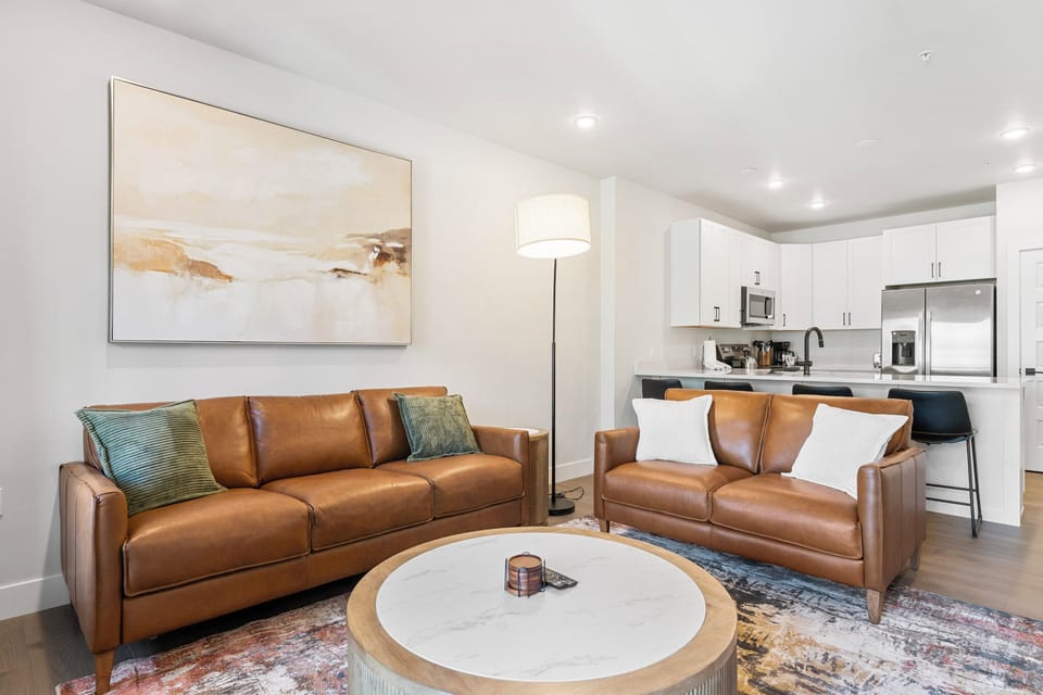 Picture yourself unwinding on plush leather sofas, gathering around the warm fireplace, or enjoying your favorite shows on the wall-mounted TV.