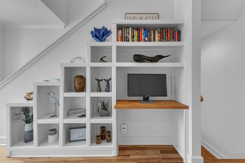 Discover your perfect reading nook with built-in shelving, nautical touches, and a dedicated workspace beneath the stairs.