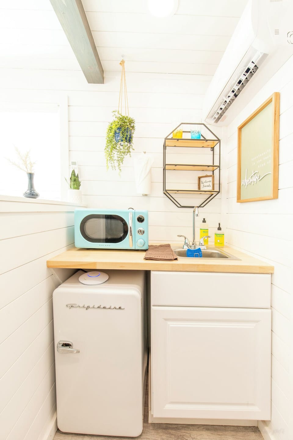 The kitchenette features a mini fridge and a microwave