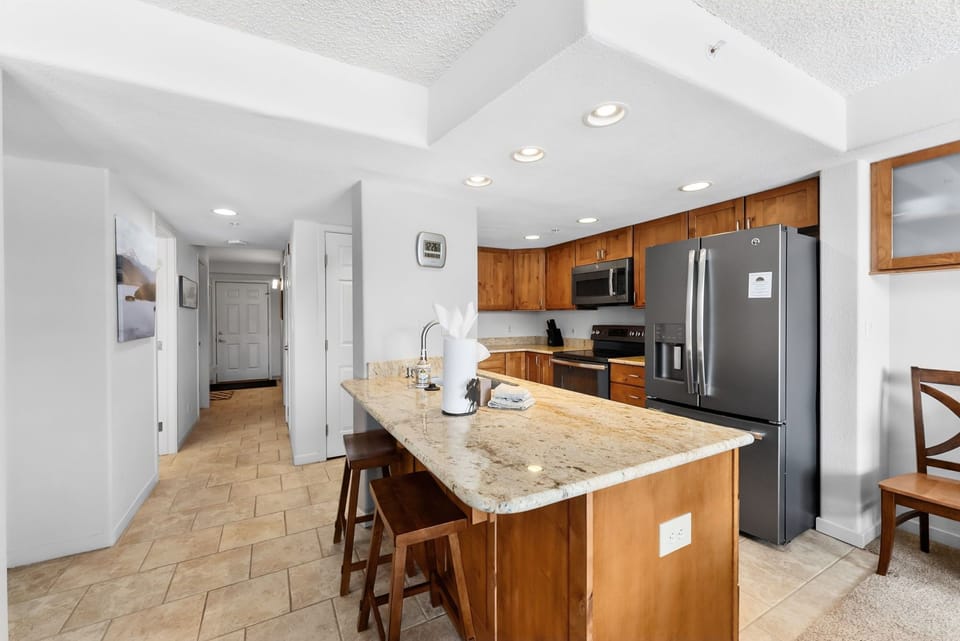 Your spacious kitchen features granite countertops, stainless steel appliances, and a convenient breakfast bar for casual meals.