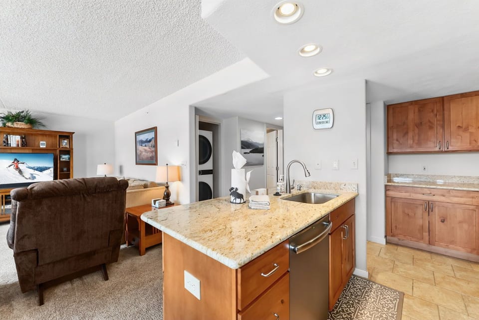 Your open kitchen flows seamlessly into the cozy living space, with granite counters and warm wood cabinets creating the perfect spot for cooking and relaxing.
