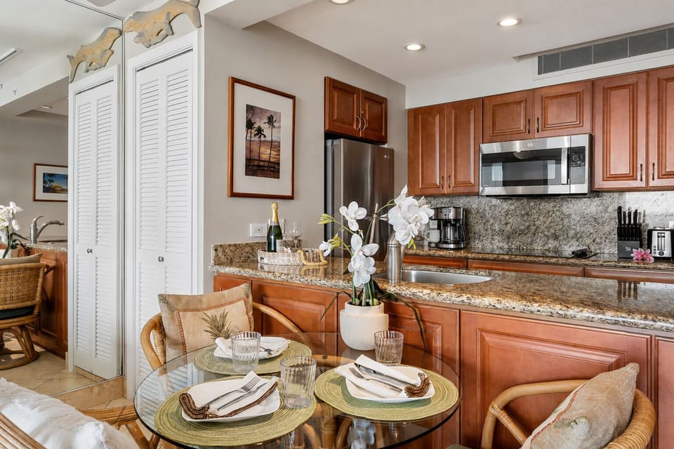 Dining area set for three beside the kitchen for relaxed meals at home.
