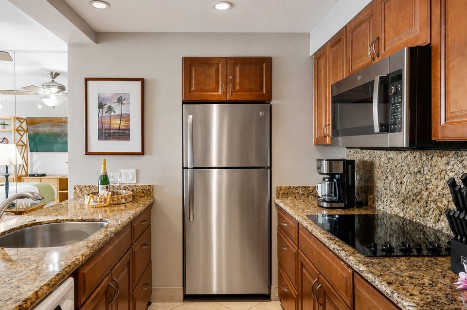 Fully equipped kitchen with granite counters and stainless appliances.